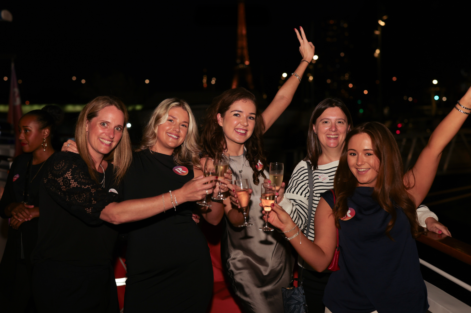 Friends celebrating together at a lively evening party with drinks.