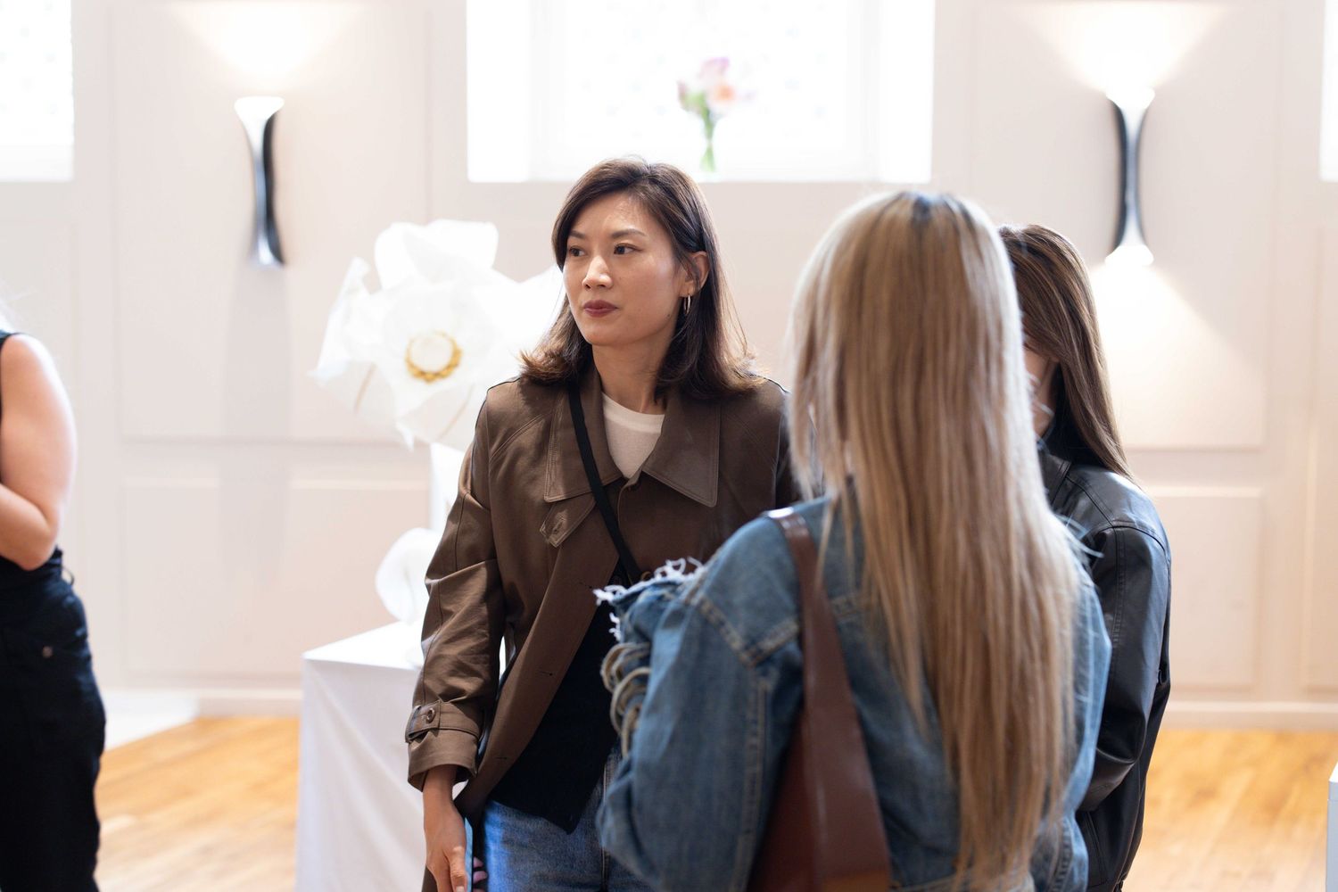 People engaged in lively conversation at a social gathering in a bright modern space.