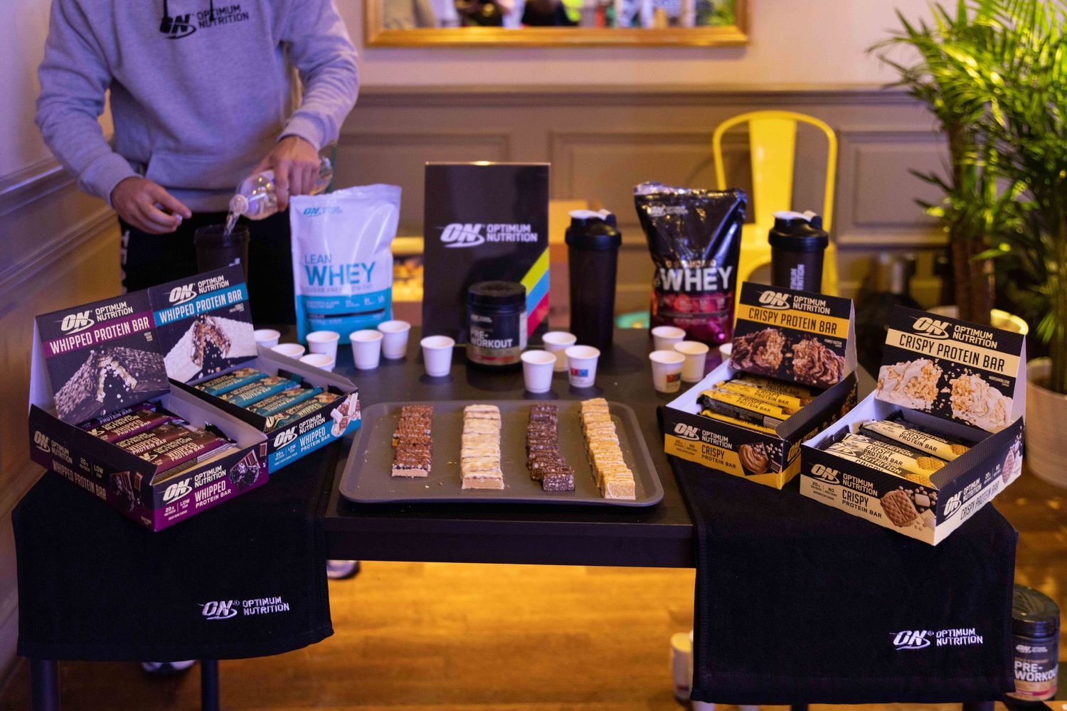 Display table with various fitness and wellness products arranged for promotional viewing.