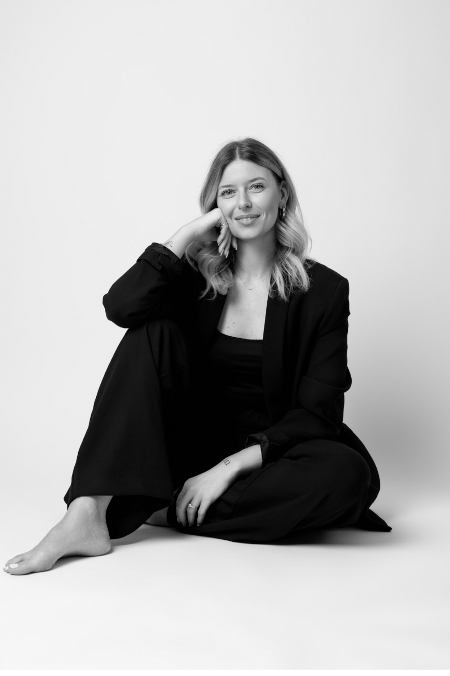 Black and white studio portraits showing artistic poses against a minimalist white background.
