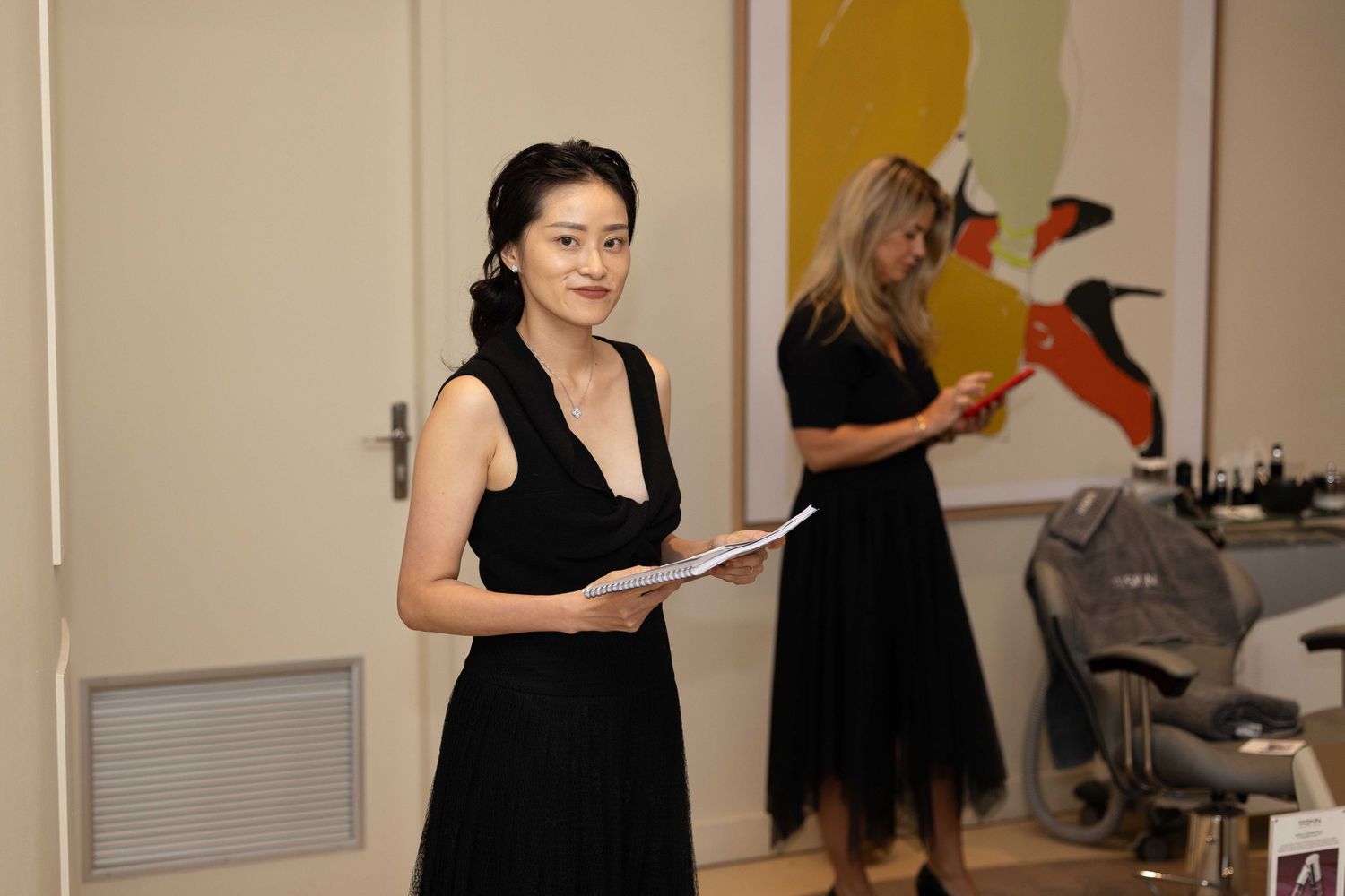 People interacting in a modern office space with wall art.