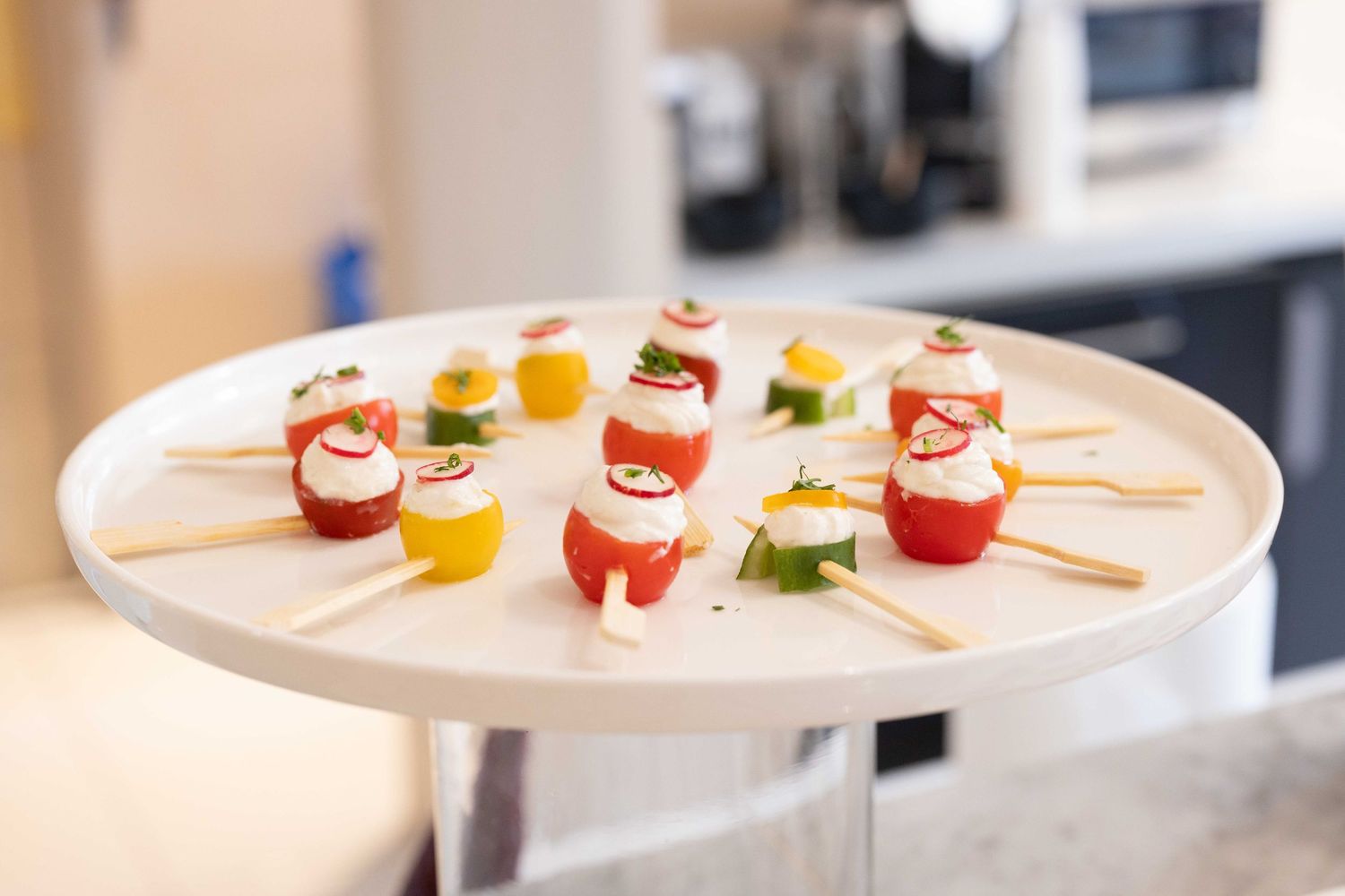 Colorful appetizers and drinks arranged on white serving platters.