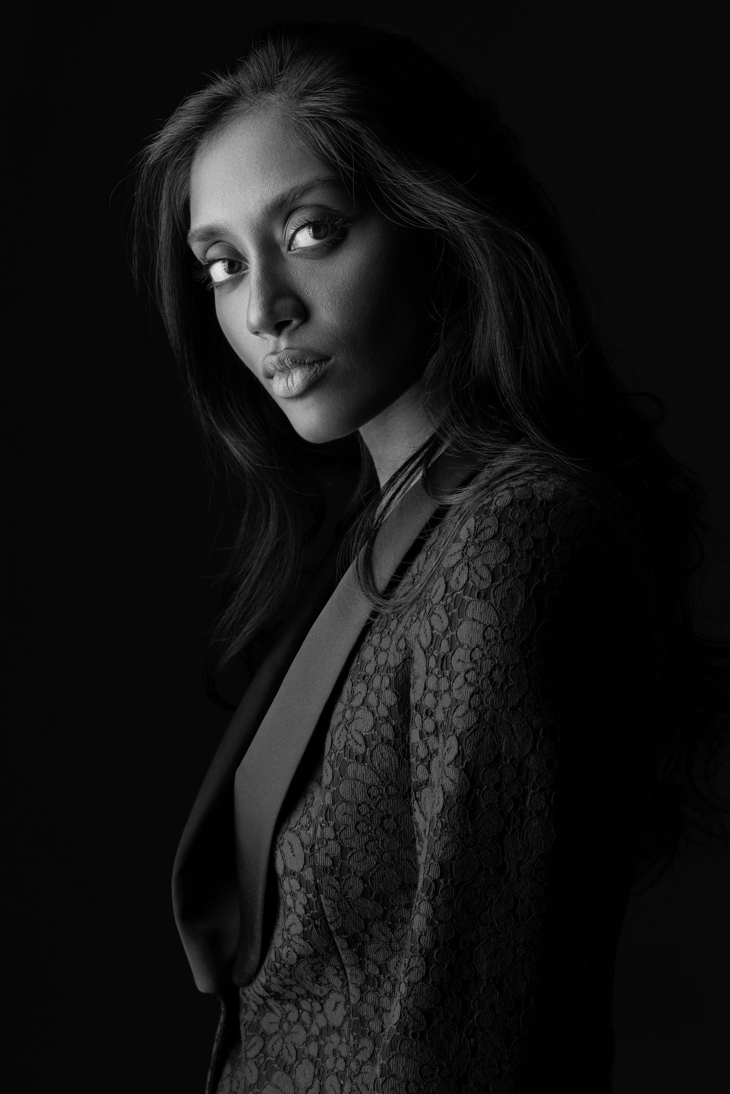 Dramatic black and white portrait series showing a figure in lace against dark shadows with artistic lighting and poses.