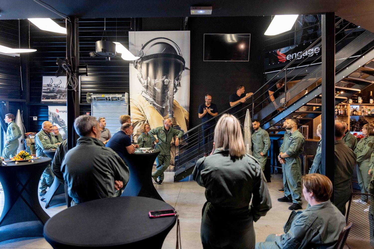 Training facility with multiple screens and displays mounted on dark walls.