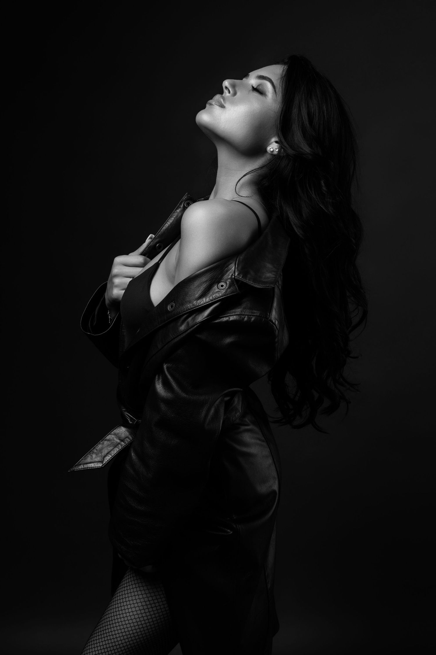 Dramatic black and white portrait series showing a person in dark clothing against a shadowy background.