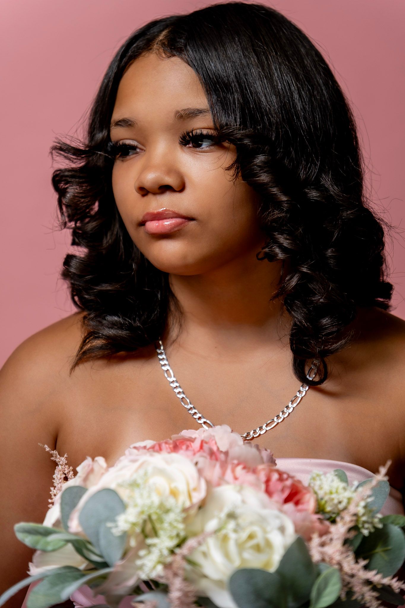 A series of five elegant portrait photos against a pink backdrop with white and pink floral arrangements.