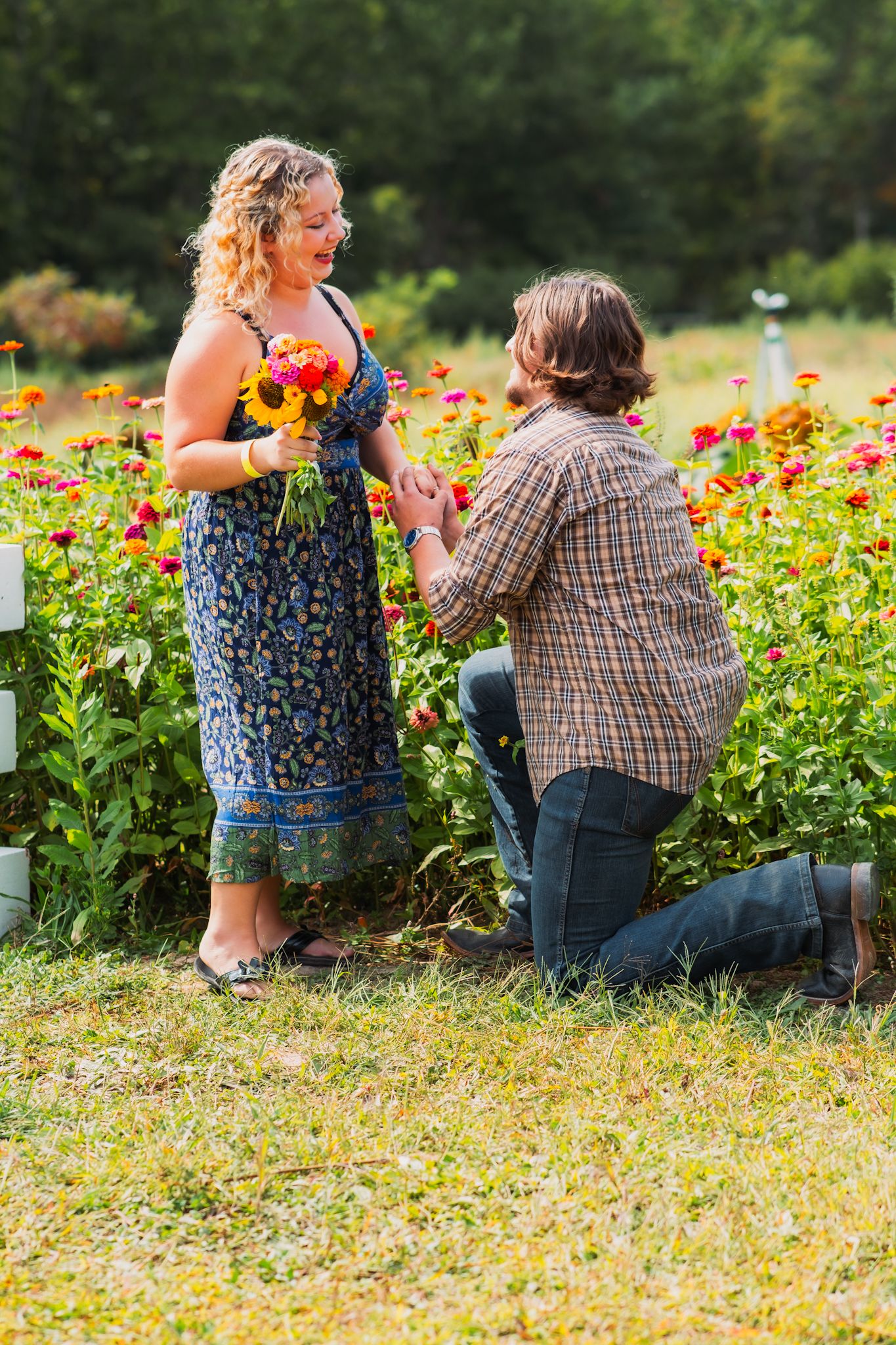 Proposal moment in a vibrant flower garden filled with orange blooms.