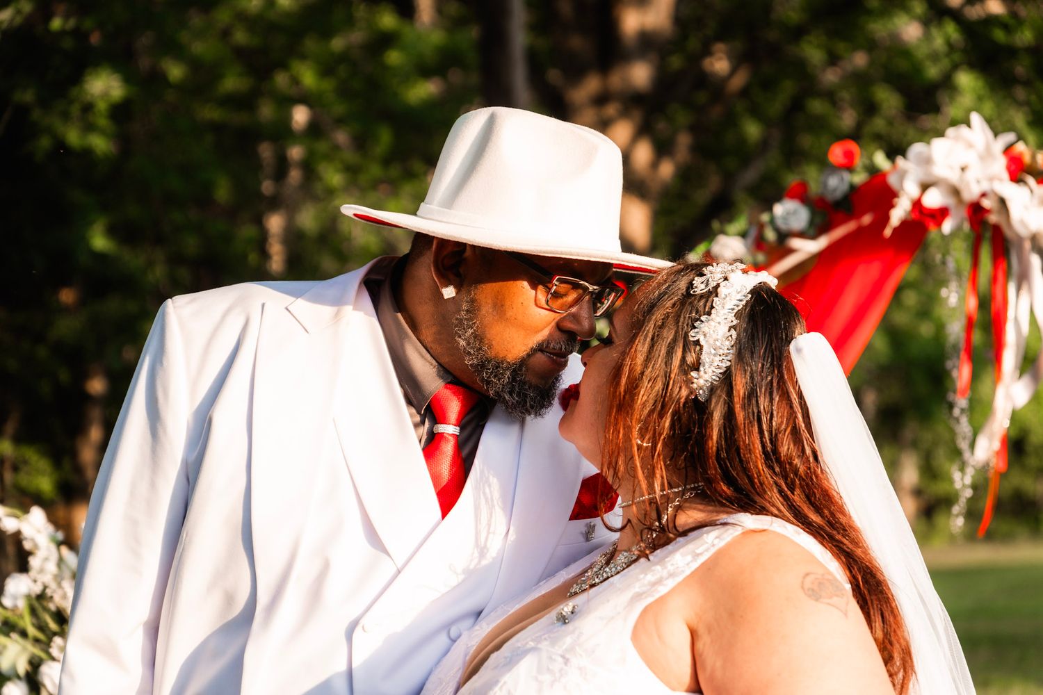 Romantic outdoor wedding moment captured in natural sunlight.