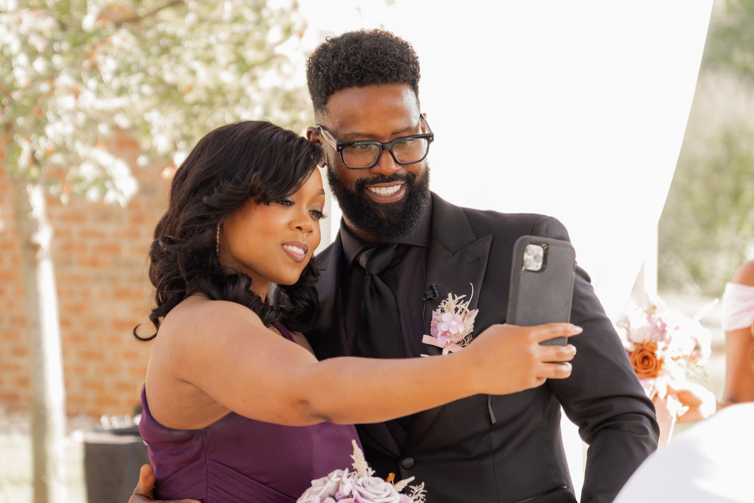 Wedding guests take a selfie together during the celebration.