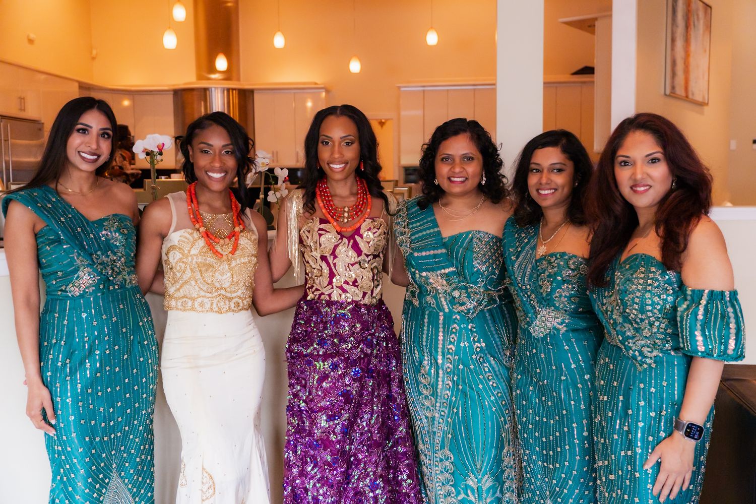 Formal event gathering with sparkly dresses and elegant decorations.