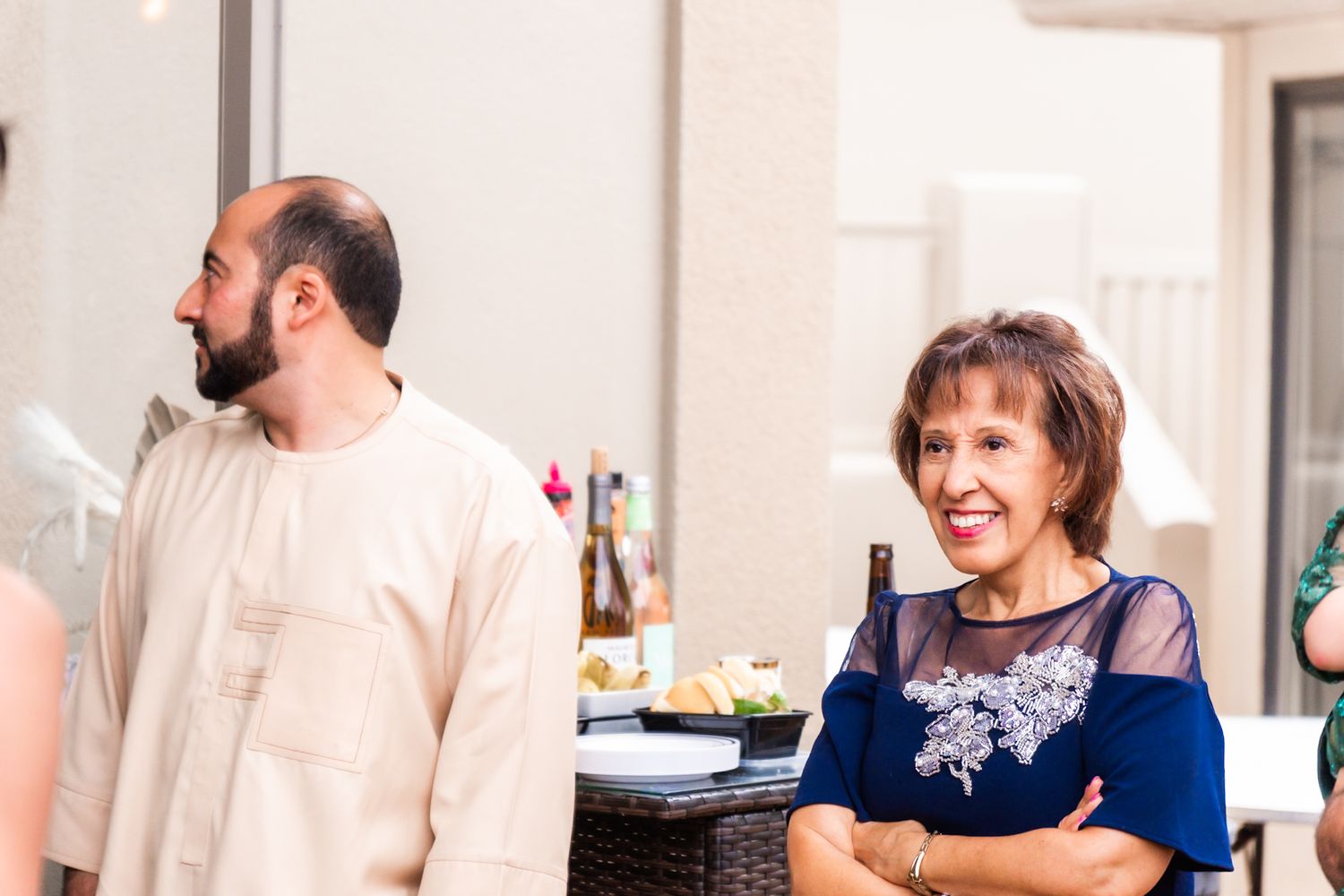 Candid moment at an indoor reception with warm lighting and casual atmosphere.