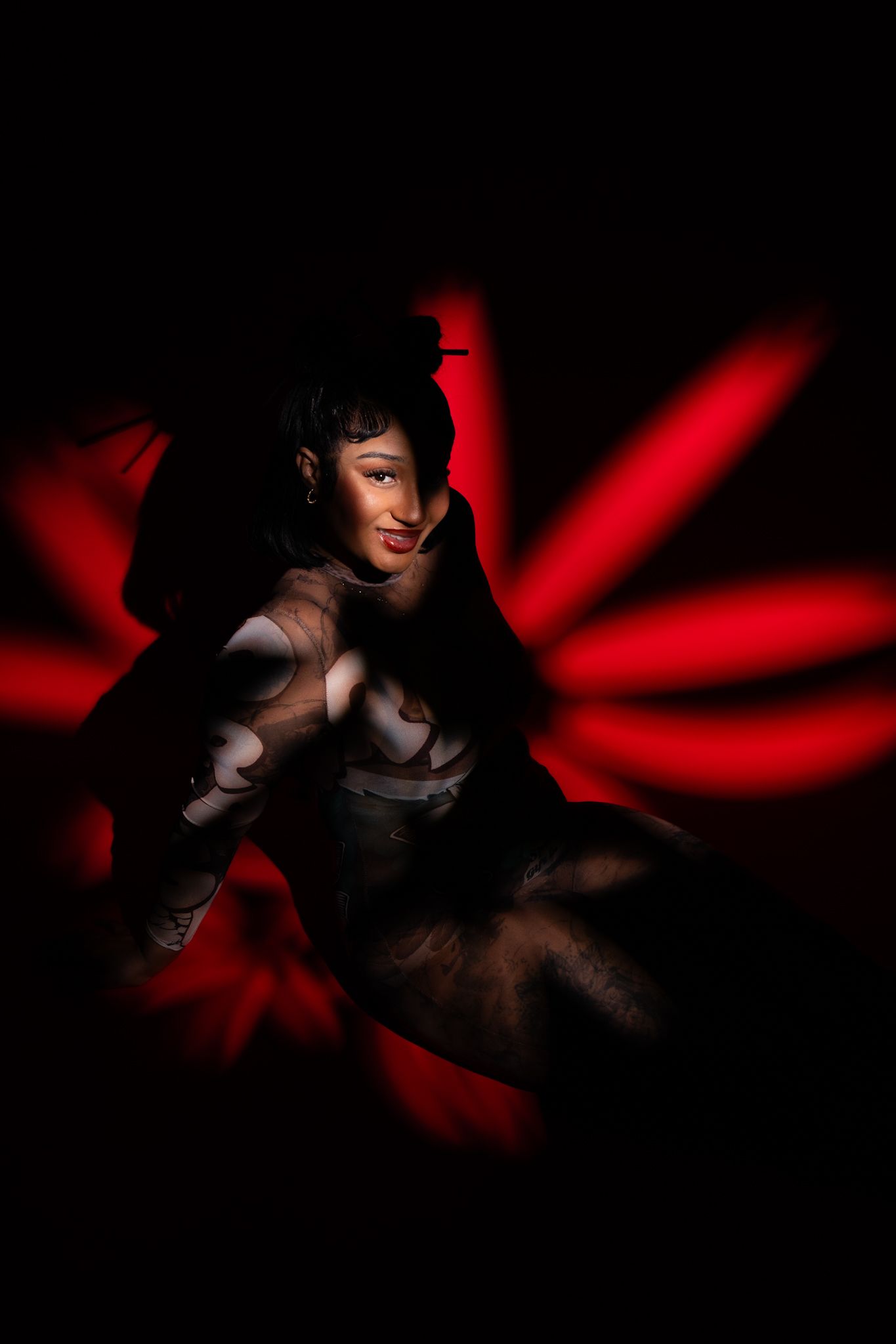 Dramatic artistic photo sequence showing figure emerging from darkness with striking red lighting effects.