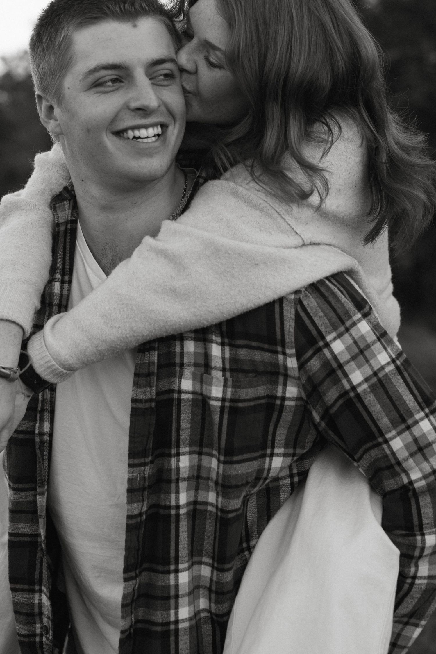 Intimate couples photo with a woman kissing a man on the cheek in central texas