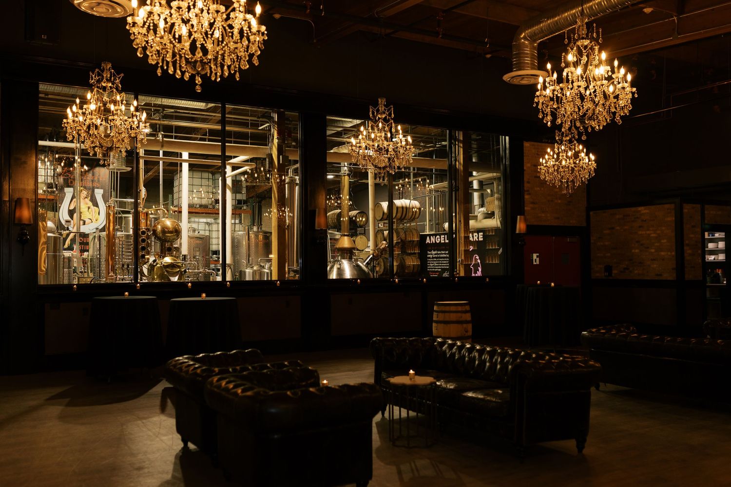 Elegant dark bar lounge with crystal chandeliers, leather sofas, and illuminated display cases.