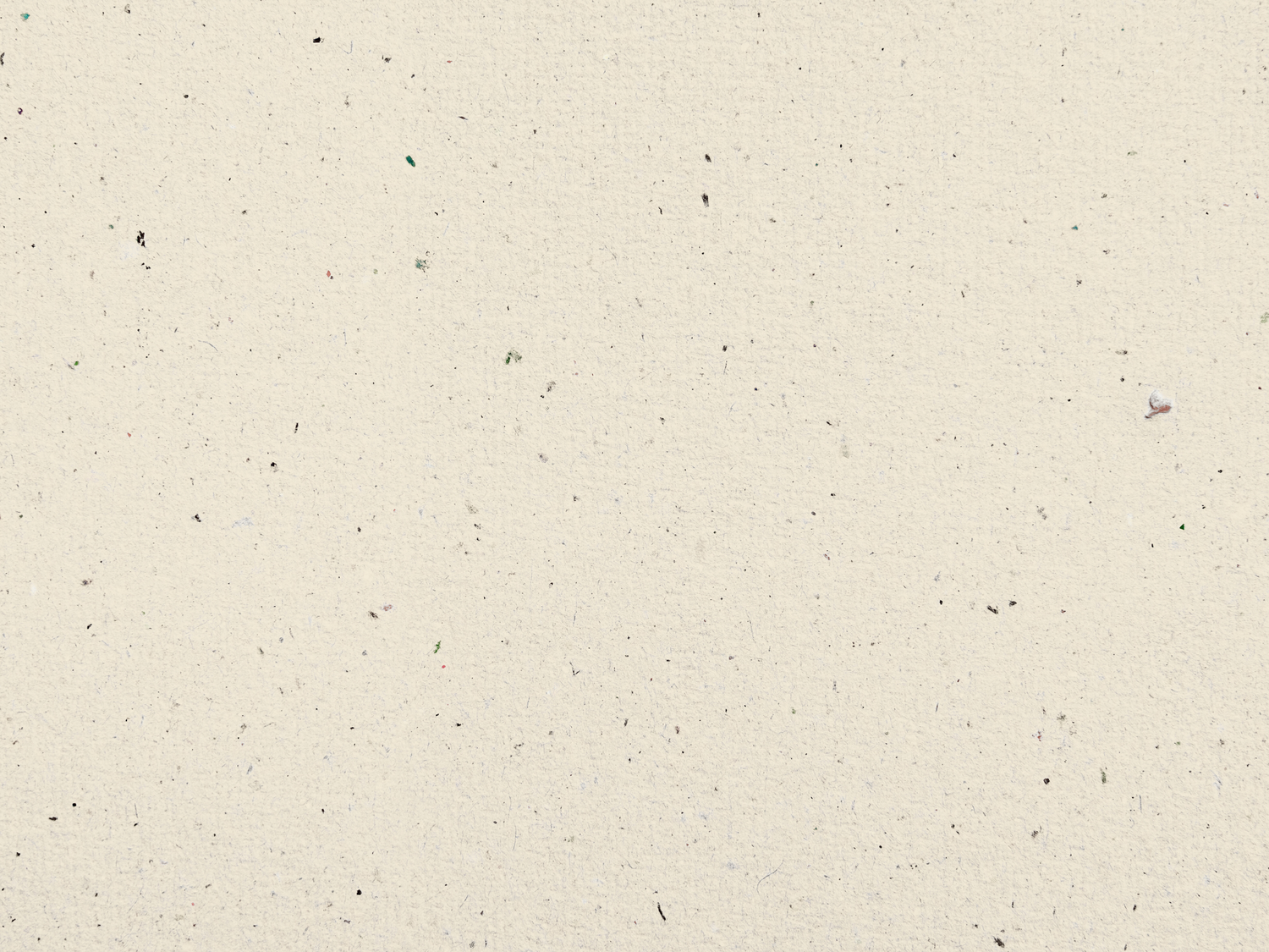 A textured beige or cream colored paper surface with small dark specks scattered throughout.