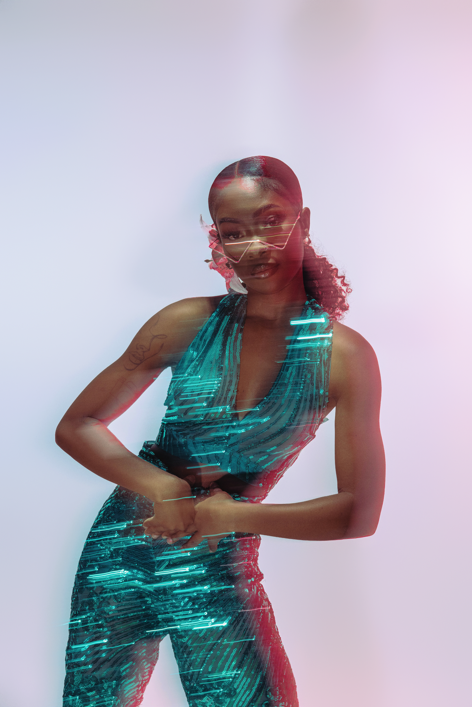 Dynamic fashion portrait with double exposure effect showing model in emerald green ensemble.