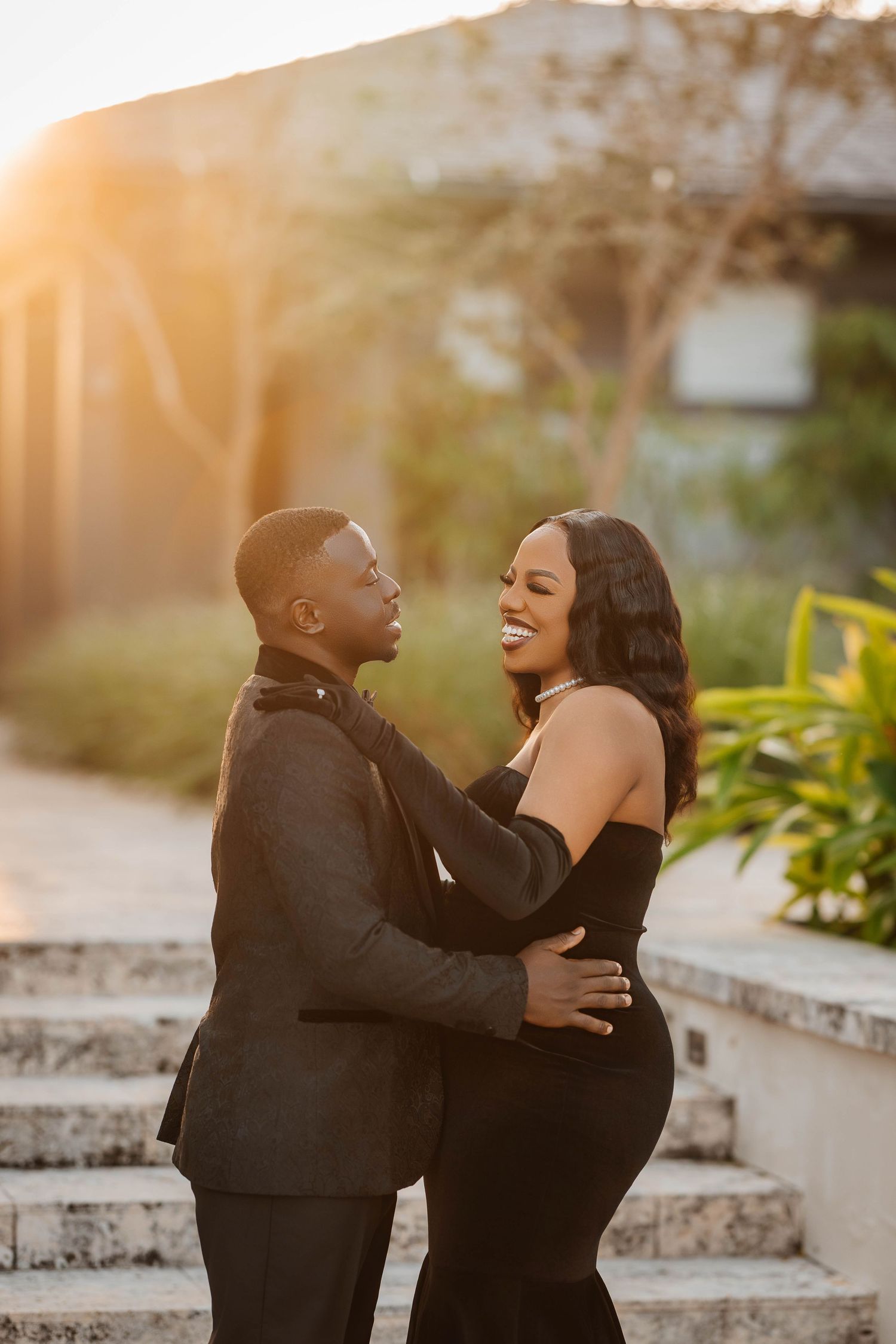 A couple shares joyful laughter together during an outdoor sunset photo session at The Island House