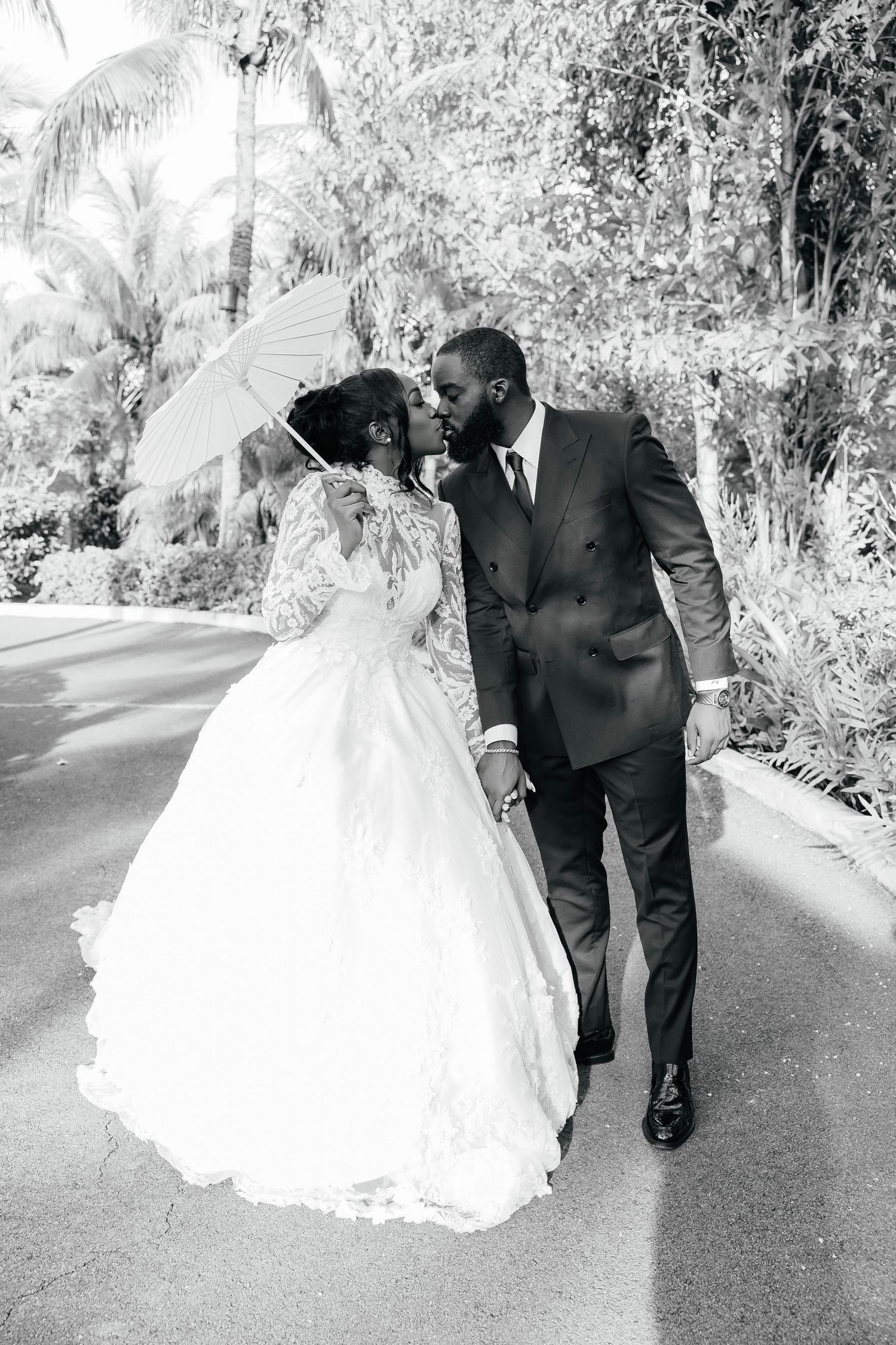 An elegant black and white capture of newlyweds sharing a tender moment.