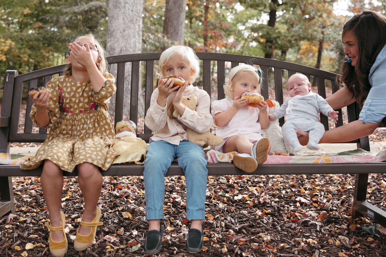 A collection of outdoor family photos taken in autumn with fallen leaves on the ground.