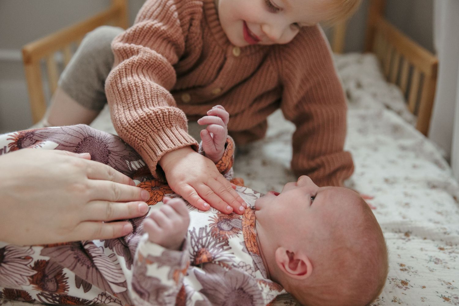 Close-up view of infant care moment in soft natural lighting.