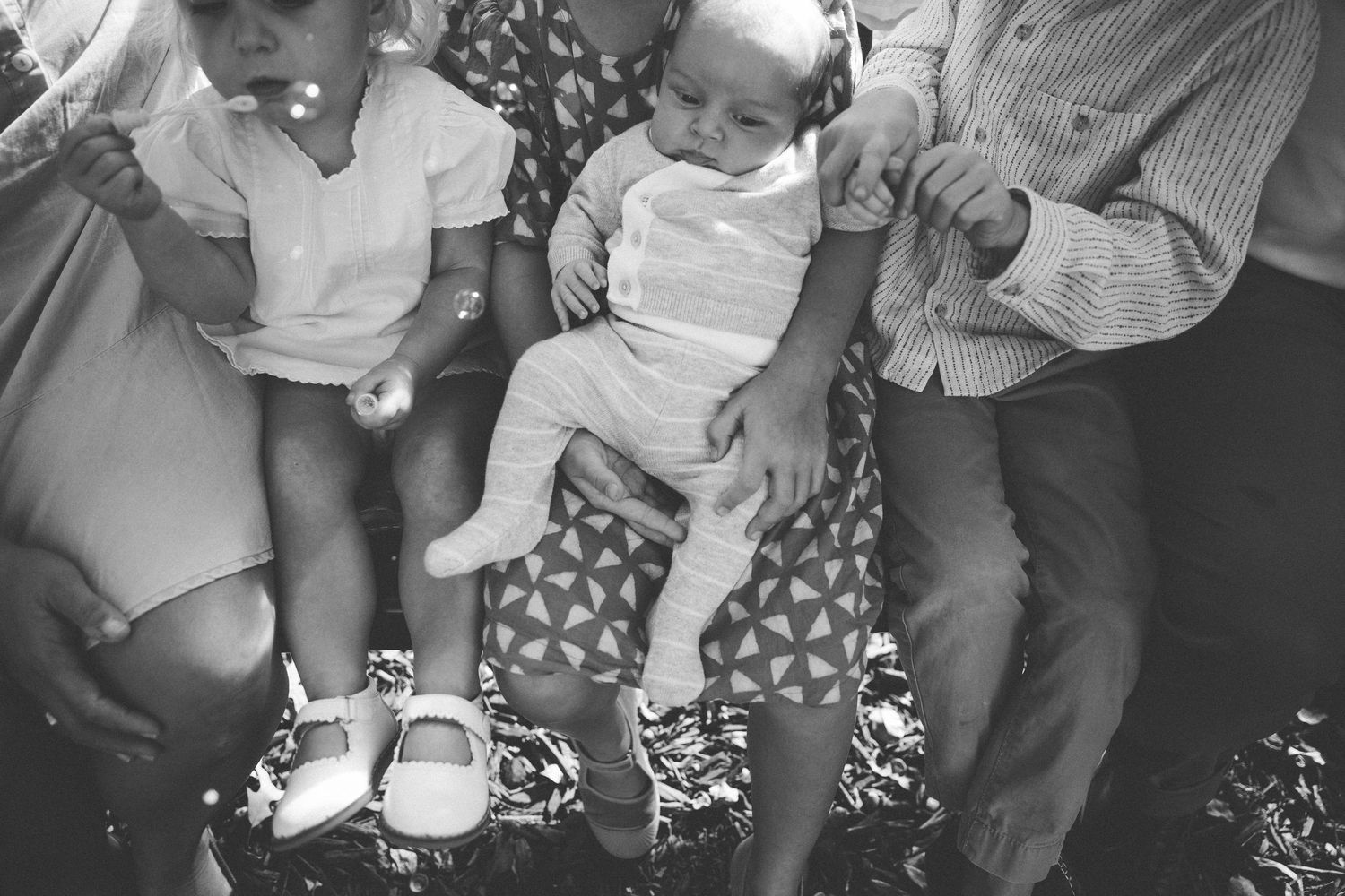 A series of black and white photos showing a baby's growth progression over time.
