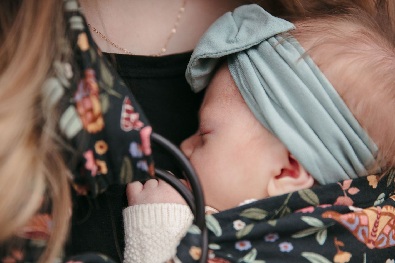 A series of intimate close-up photographs showing tender moments between parent and baby in natural window light.