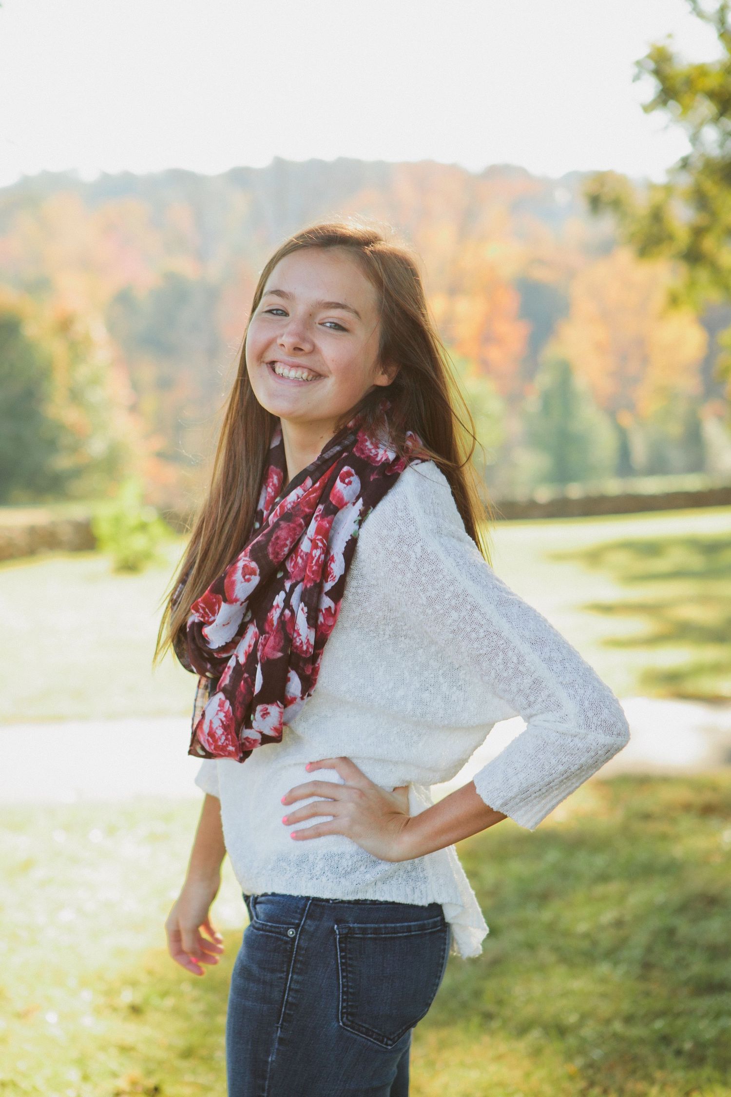 Autumn outdoor portrait with floral scarf and white sweater.