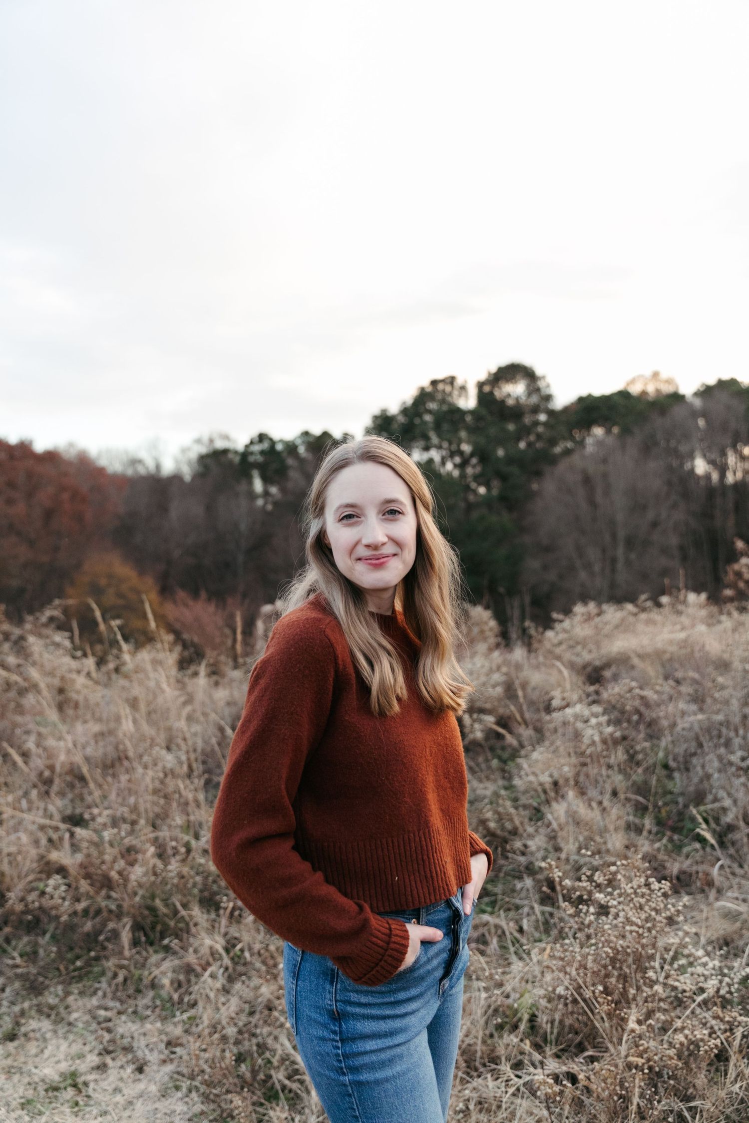 Autumn portrait with rustic field backdrop and warm evening sunlight.