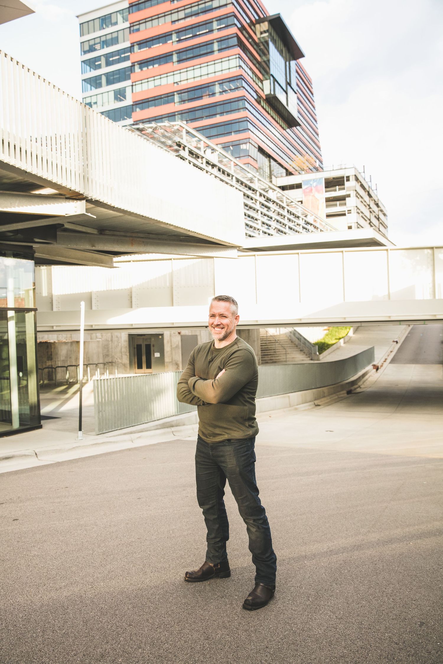Modern urban architecture with person standing in front of geometric building structure.