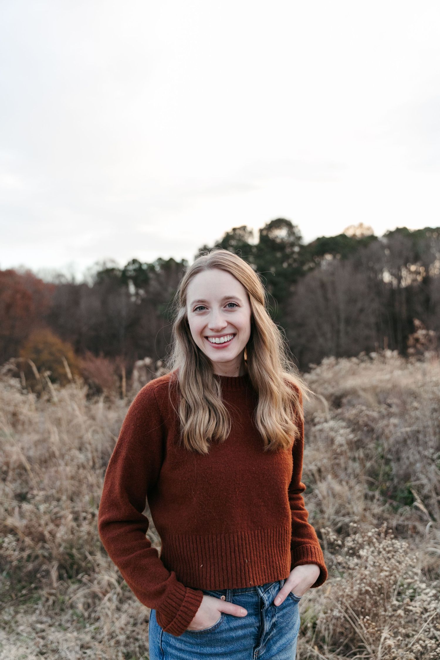 A cozy autumn portrait in a rustic field setting with warm lighting.
