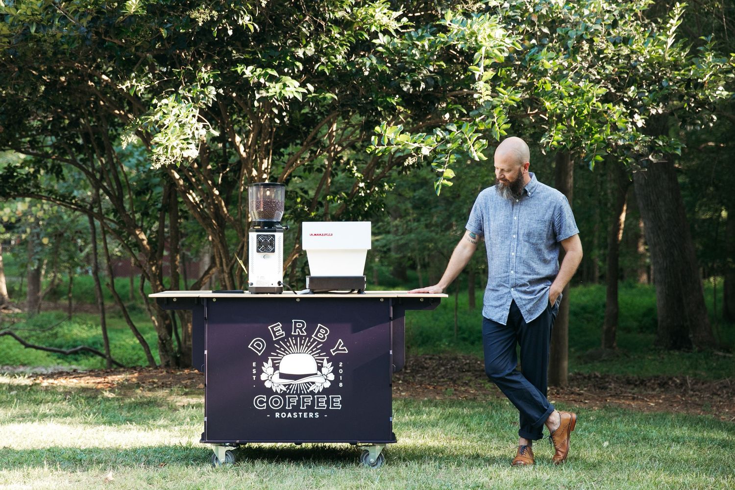 Coffee roasting business cart displayed outdoors with Derby Coffee Roasters branding.