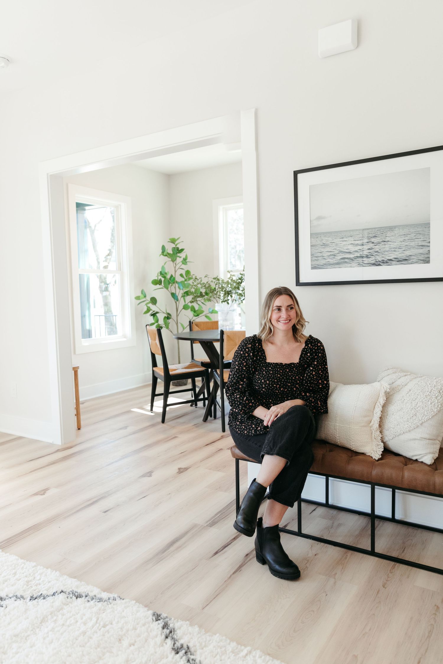 Bright white interior space with light wood floors, modern furniture, and minimalist decor.