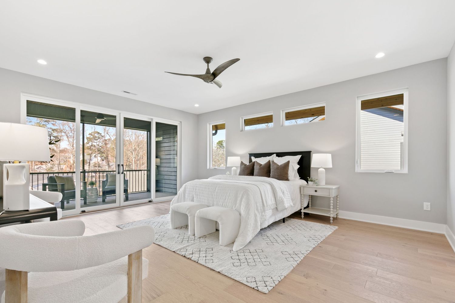 Modern room with vaulted ceilings, recessed lighting, and ceiling fan showcasing a clean, minimalist design.