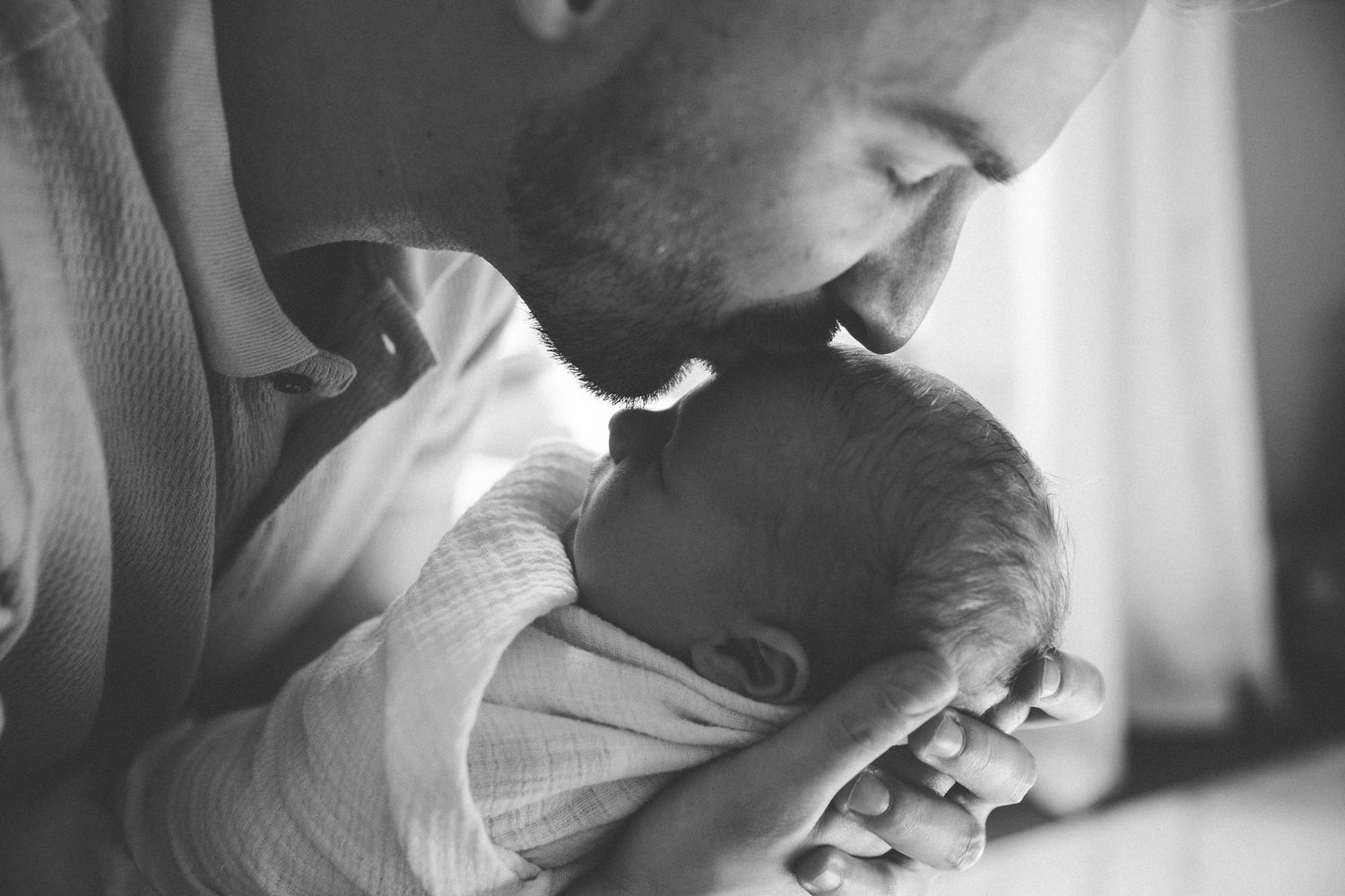 Intimate black and white portrait showing tender emotional moment.