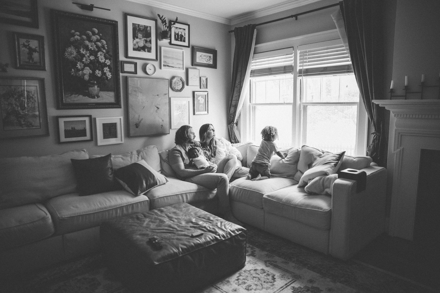 A black and white panoramic series of photos showing a bedroom interior with natural light from windows.