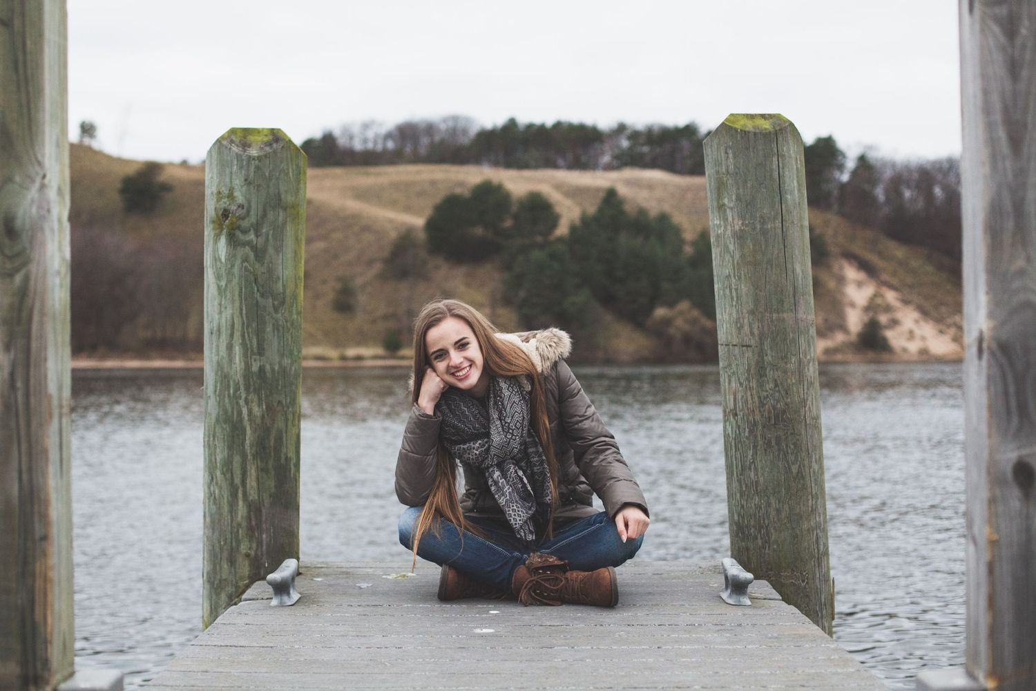 Casual portrait taken on wooden dock overlooking waterfront.