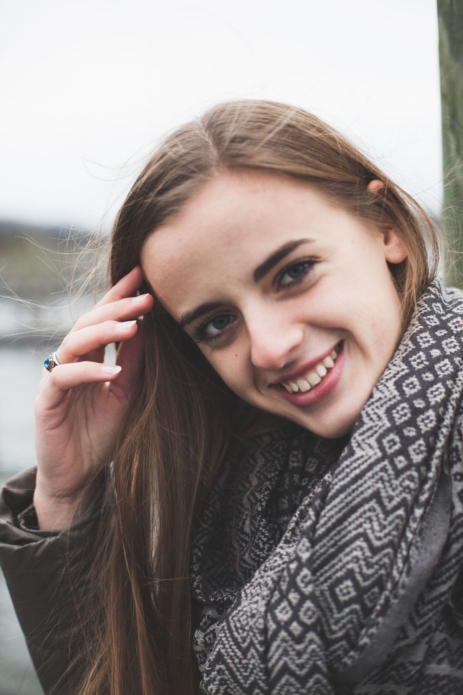 A winter portrait featuring someone wearing a patterned scarf and dark coat.