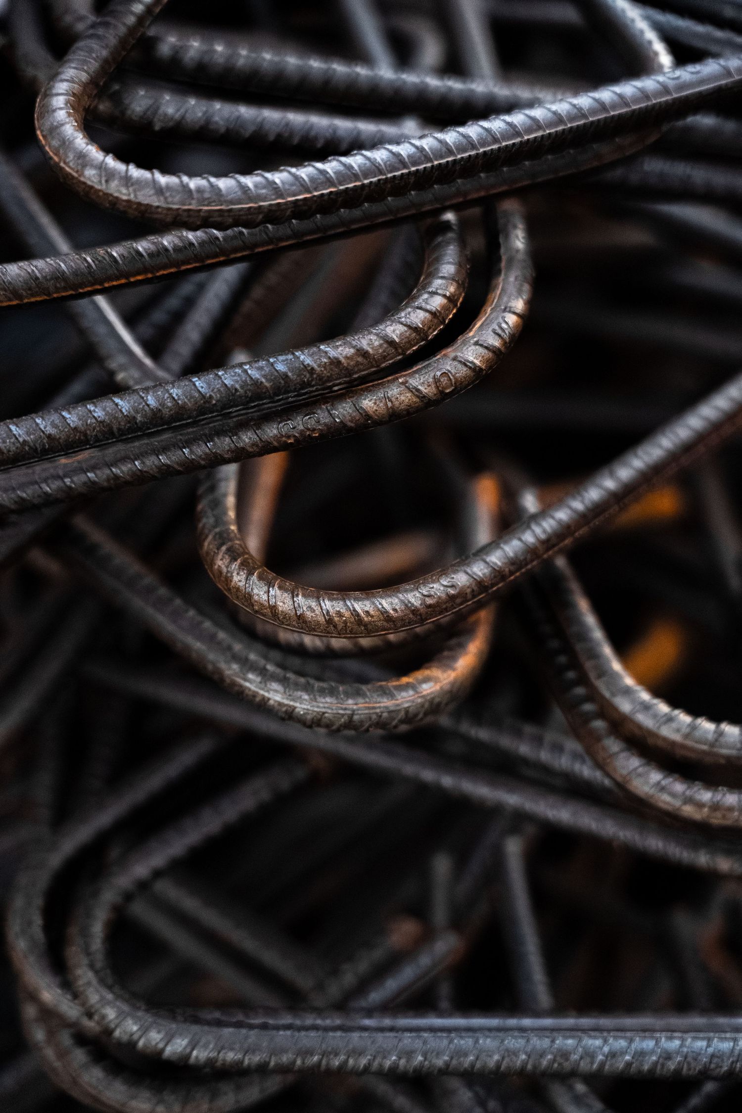 Close-up of tangled bent steel rebar used in concrete reinforcement construction.