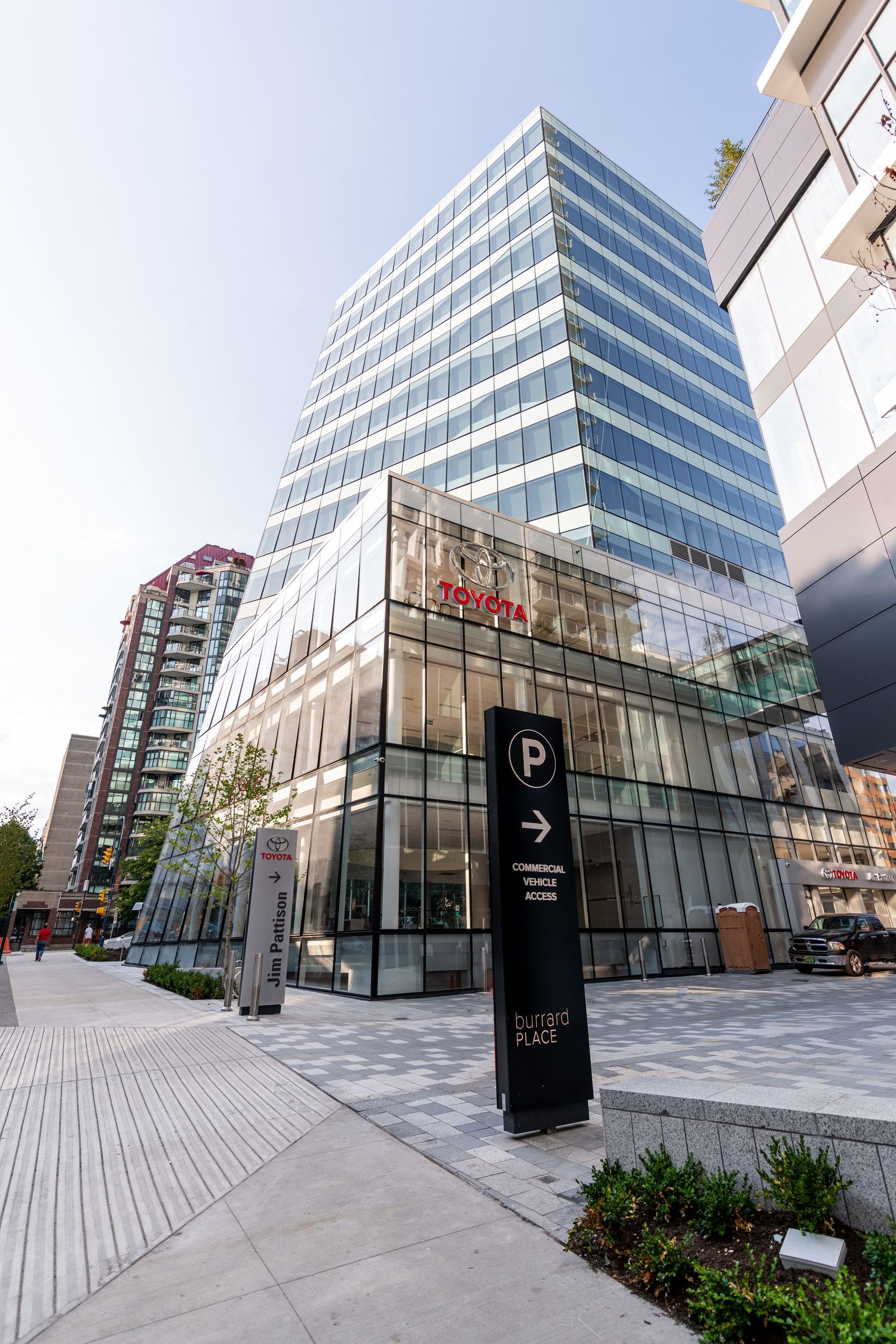 Modern glass office tower with Toyota signage and Dunsmuir Place sign on a sunny day in Vancouver.