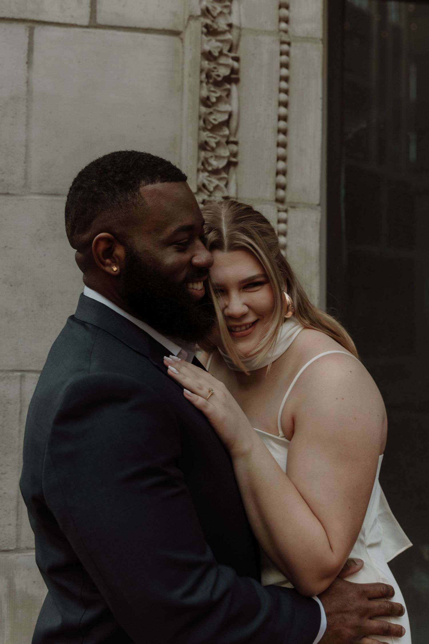 Intimate moment between a couple during a romantic engagement photoshoot.