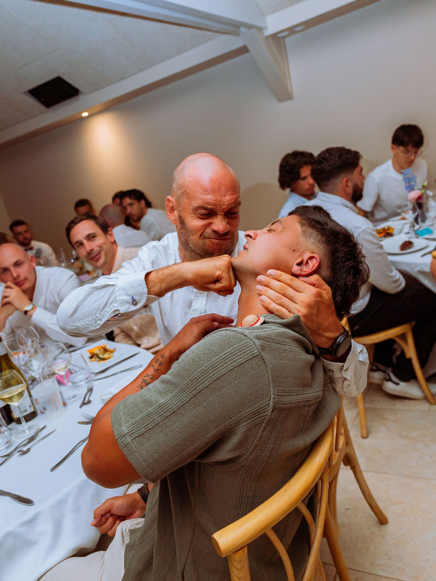 Five sequential photos show people laughing and enjoying themselves during a dinner gathering at a table.