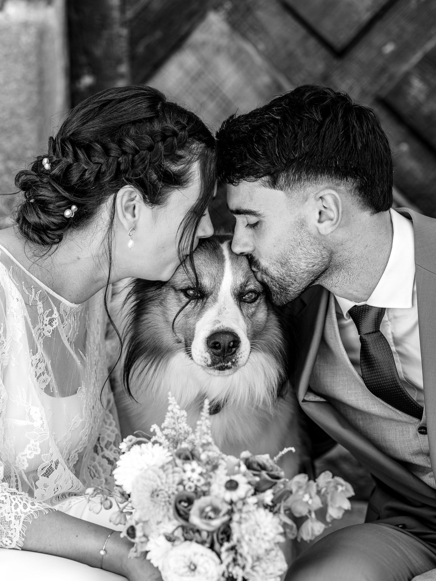 A black and white wedding photo series showing intimate moments between newlyweds and their beloved dog.
