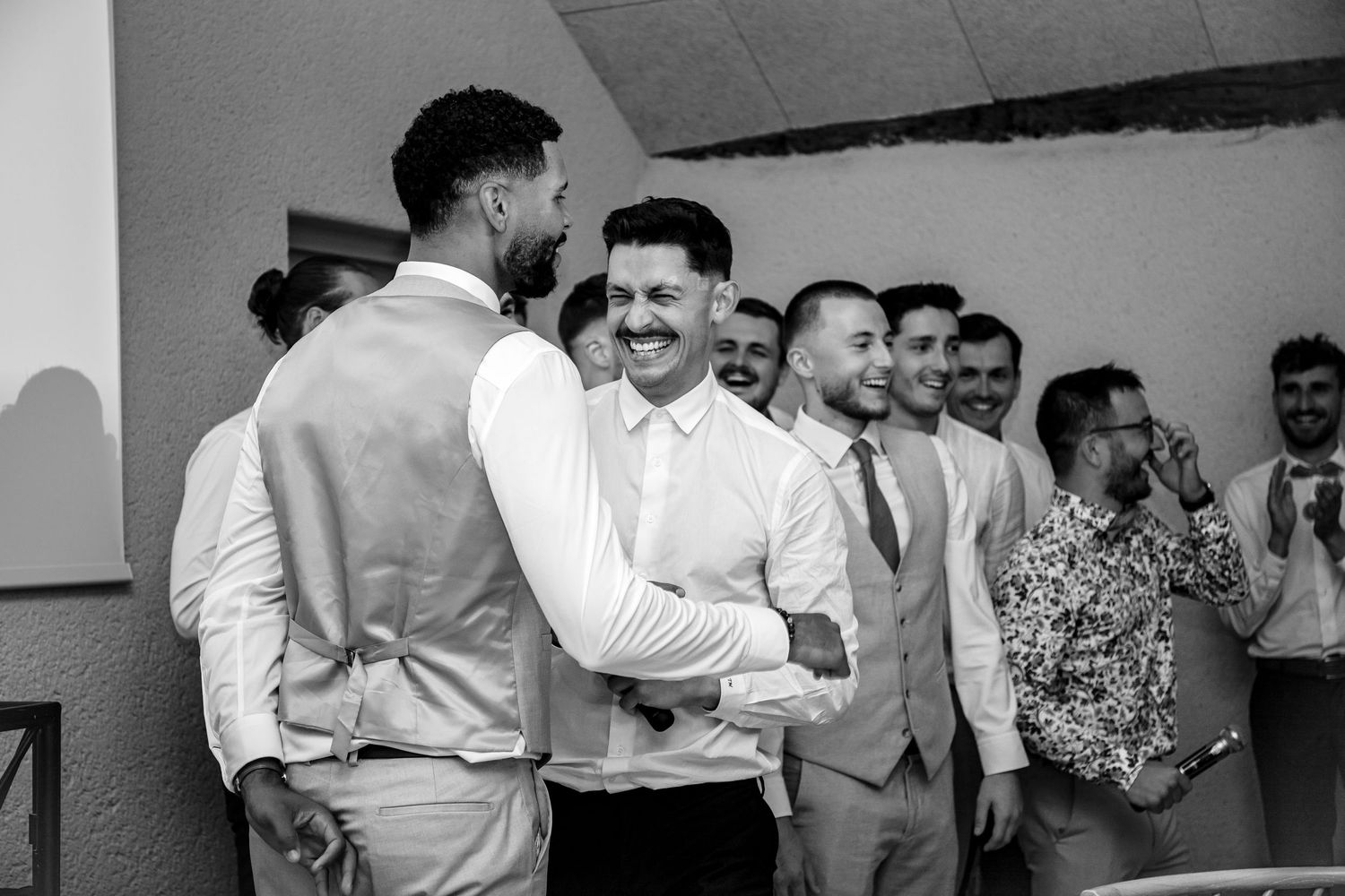 Black and white photo showing couples dancing together at what appears to be a social gathering or celebration.