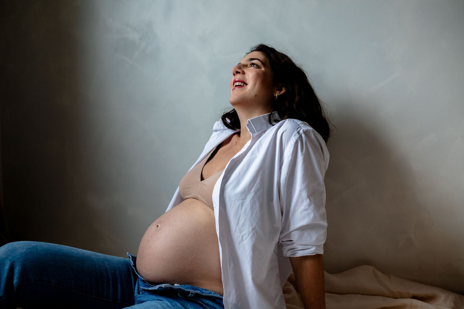 Photo de grossesse maman dans sa chemise blanche