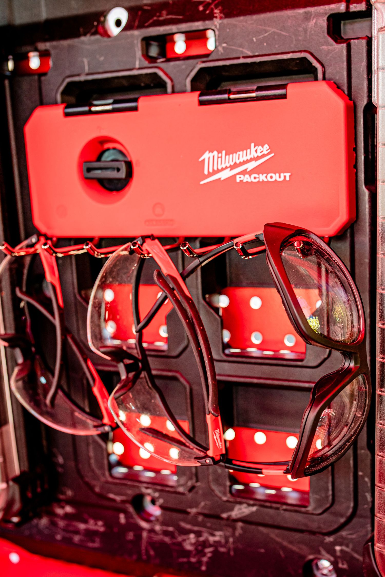 Milwaukee Packout storage system with red cases and integrated lighting.