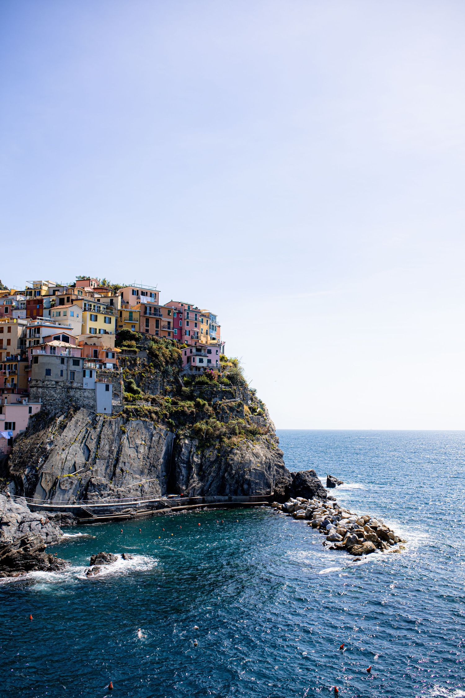 Colorful houses perched on dramatic cliffs overlooking the Mediterranean Sea in Cinque Terre, Italy.