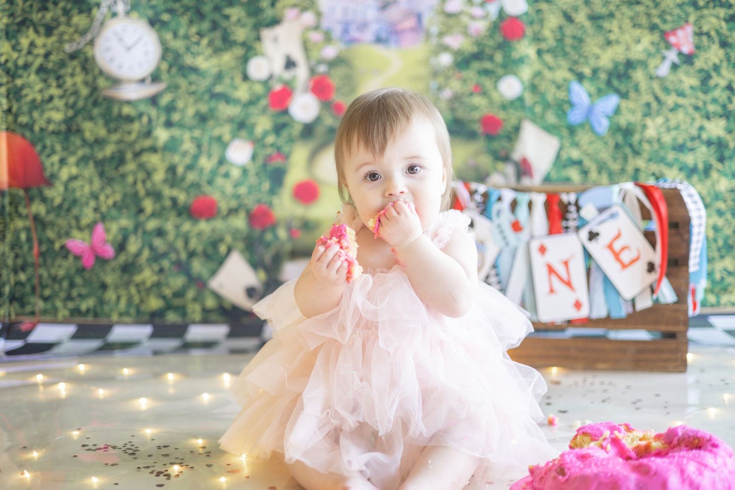 Pink tulle dress and festive holiday decor create a magical scene with scattered confetti on the floor.