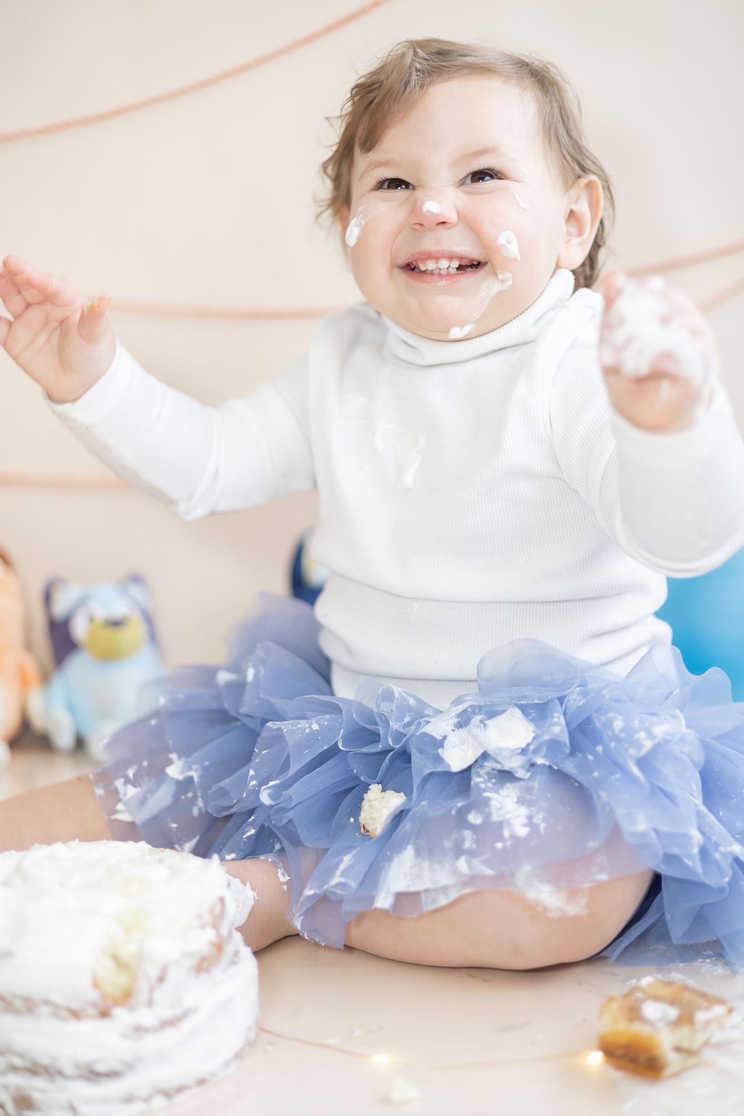 A celebratory moment in a blue tutu and white top with decorative balloons and festive setting.