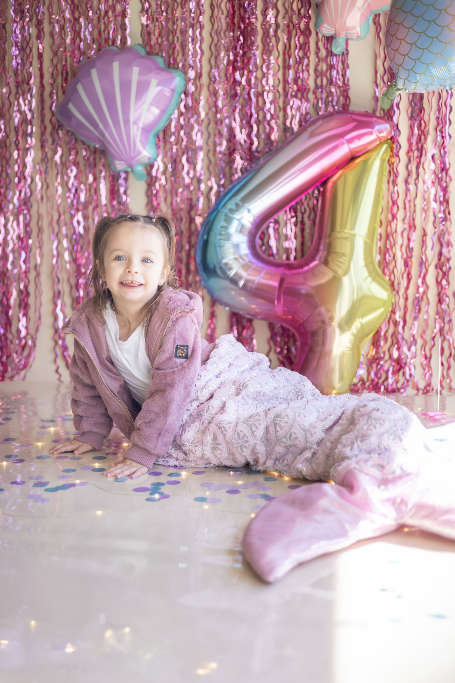 A set of four photos showing a pink-themed birthday celebration with sparkly backdrop and colorful balloons.