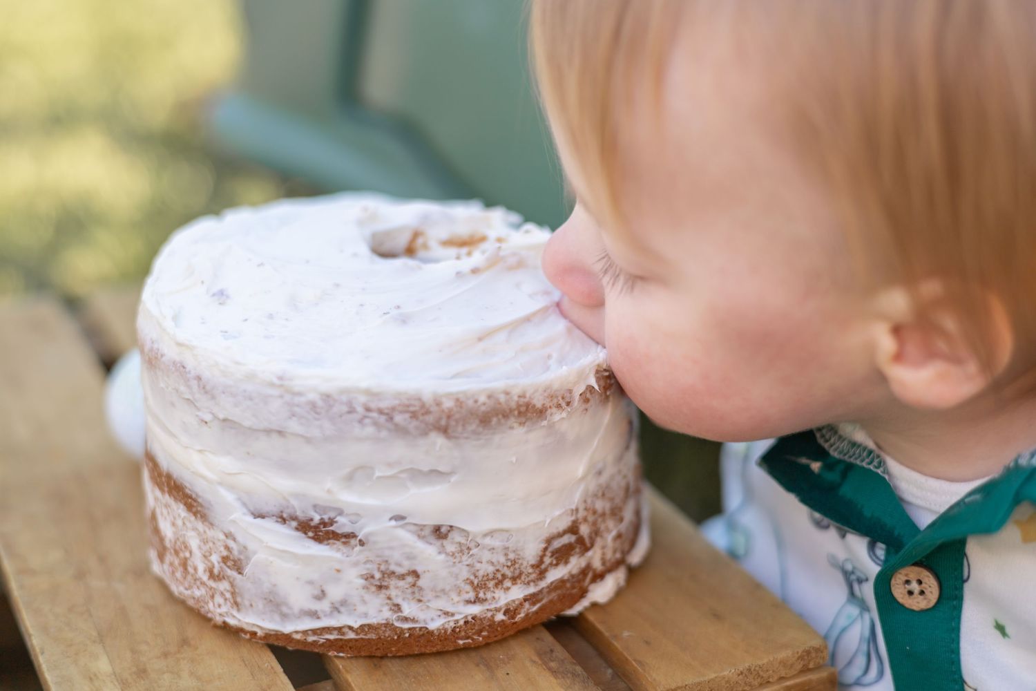 Small child's hands greedily reaching for a powdered sugar donut on a white plate.